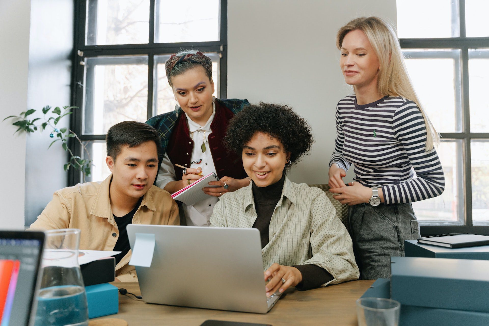 A Group of People Looking at a Laptop<br />
